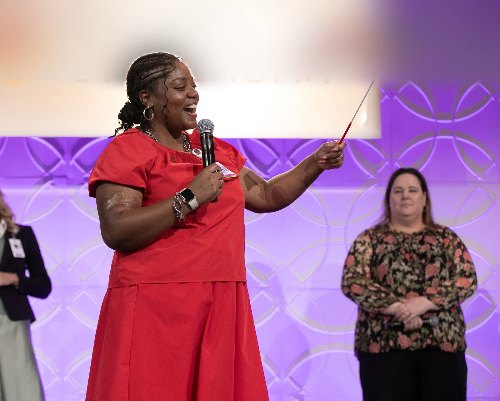 Angela leading a room from the stage
